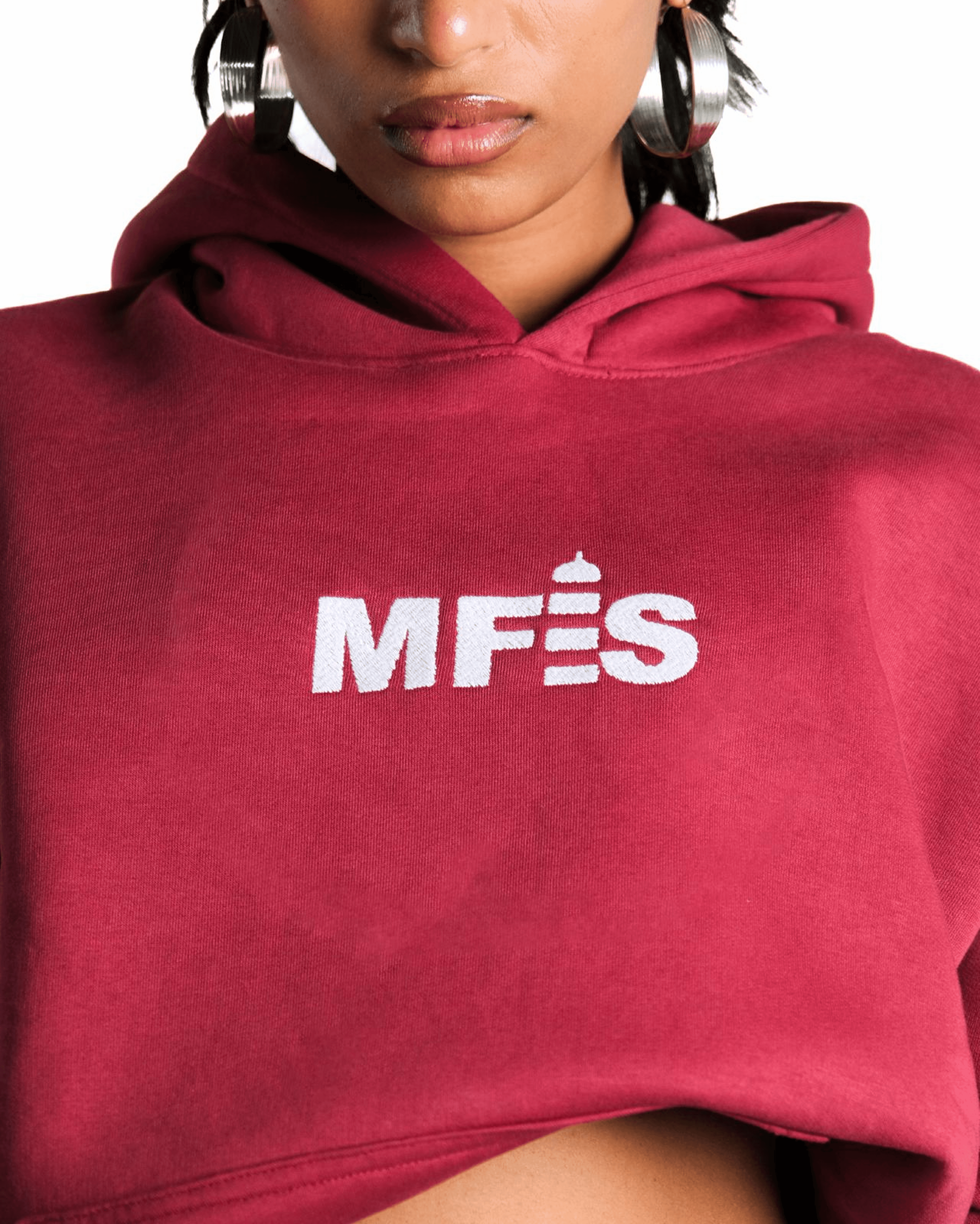 Close-up of white MFES embroidery on a maroon hoodie chest